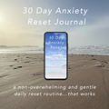 A smartphone centered over a beach scene displays the cover of a '30 Day Anxiety Reset Journal.' Large white text above and below reads '30 Day Anxiety Reset Journal' and a tagline about a gentle daily reset routine.